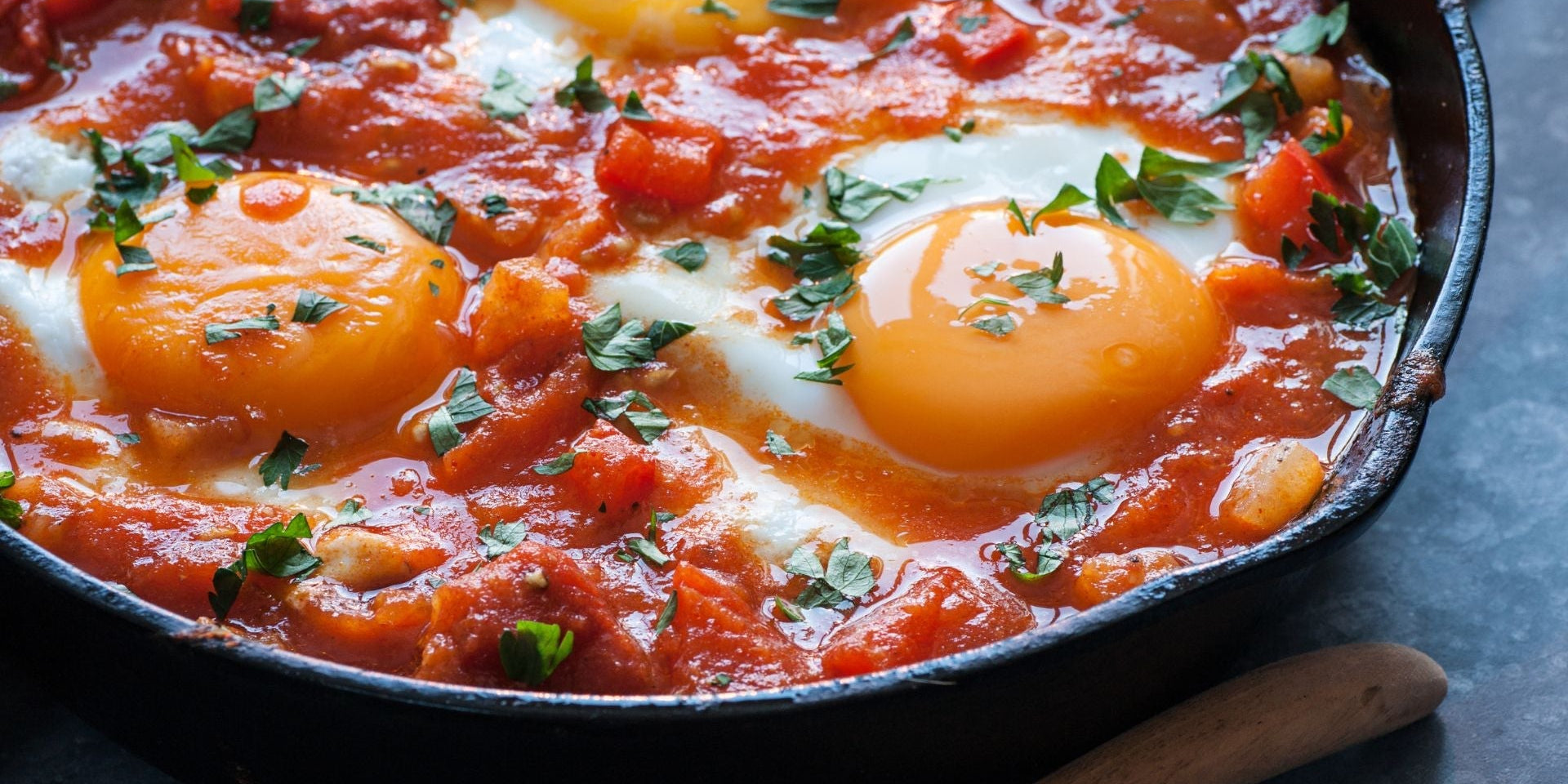 Baked Eggs and Greens in Harissa Tomato Sauce