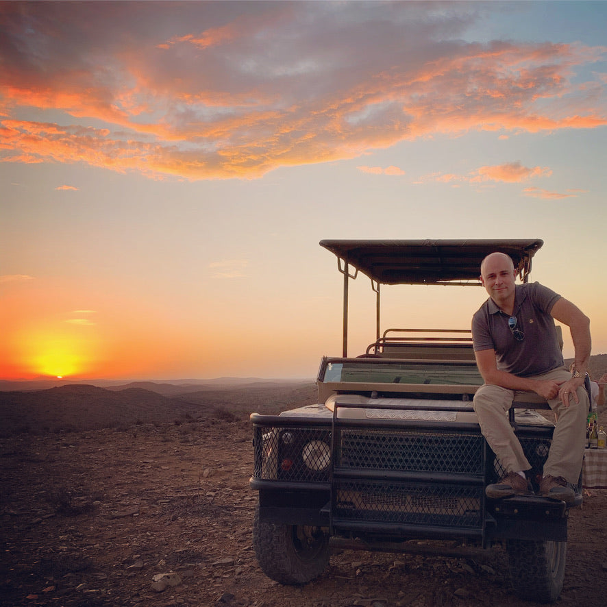 Chef Rob Springer on safari vehicle at sunset — original